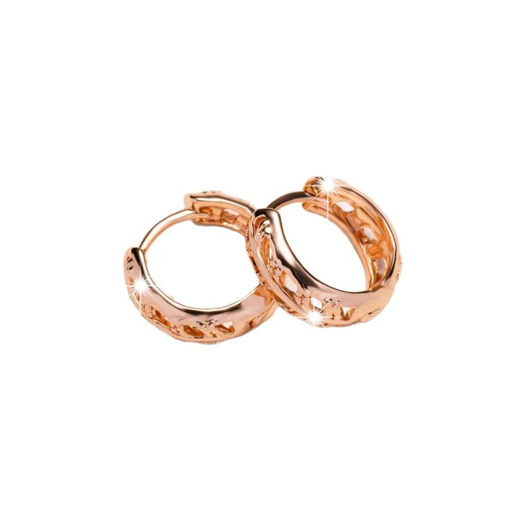 Hollowed-out copper earrings with leaf and heart designs in rose gold colour