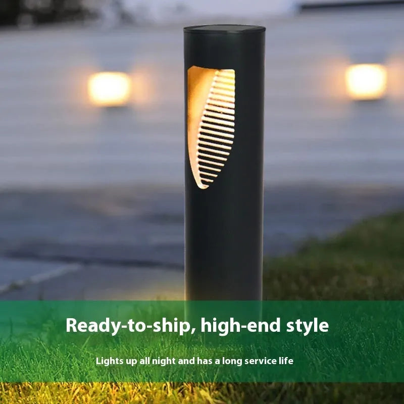 Black geometric abstract art solar-powered stainless steel garden lantern on grass.