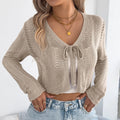 Khaki women's lace-up casual coat with hollow-out design detail on the front.