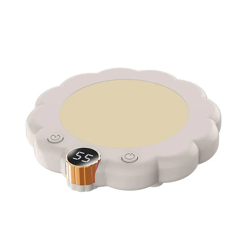 White plug-in thermal coaster on desk with push-button controls and power cord