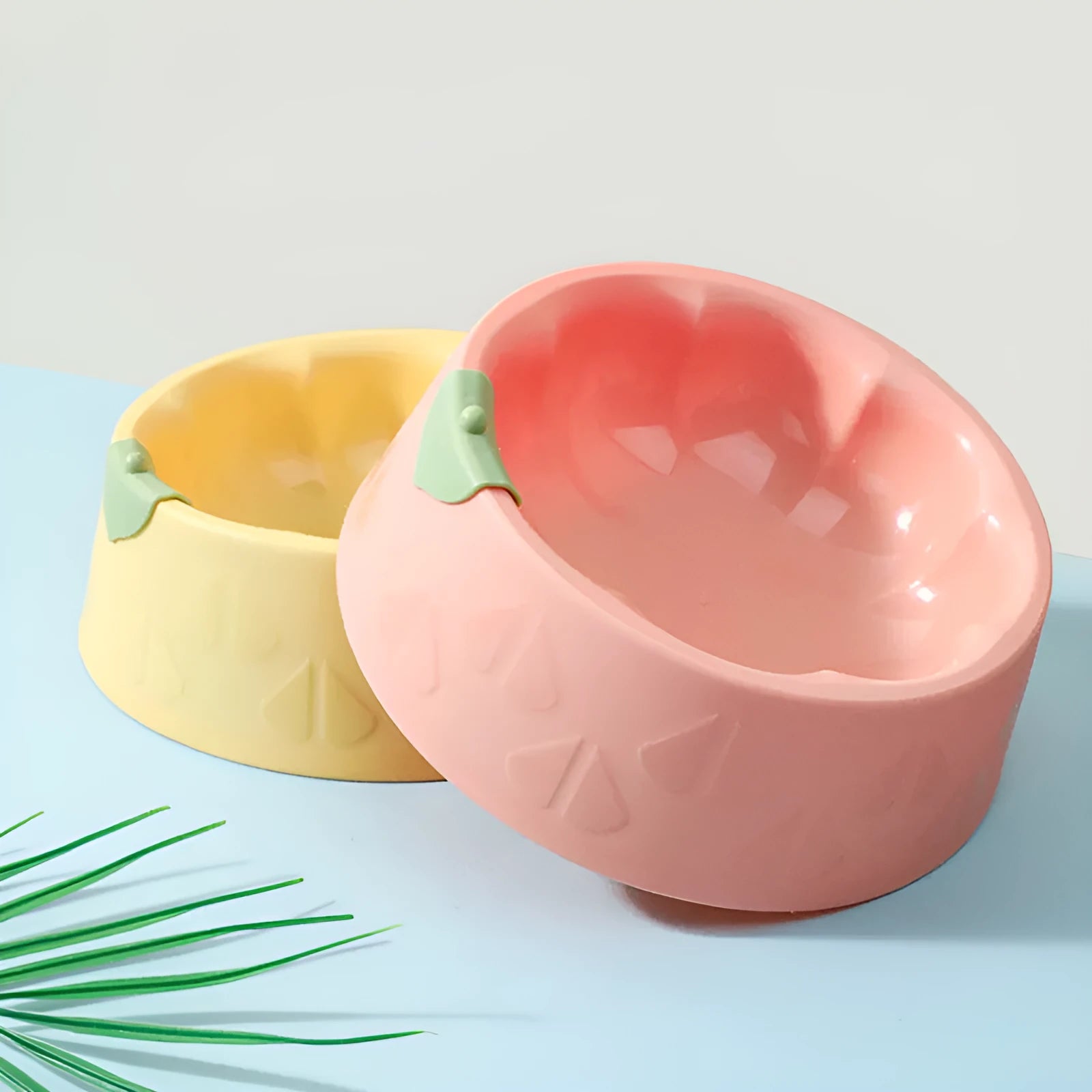 Green plastic double pet bowl for dog and cat food and water on a white background