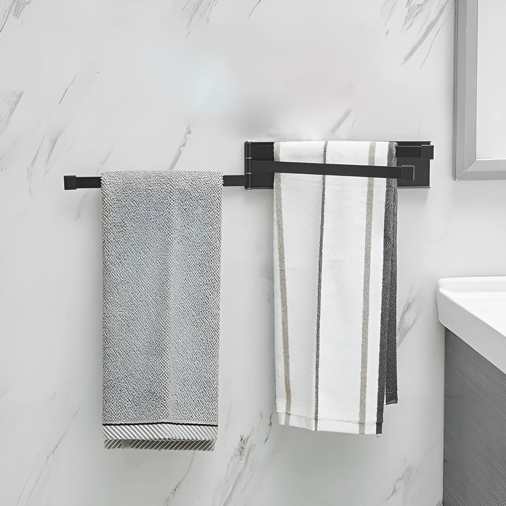 Black folding no-drill towel bar mounted on a bathroom wall with adhesive.