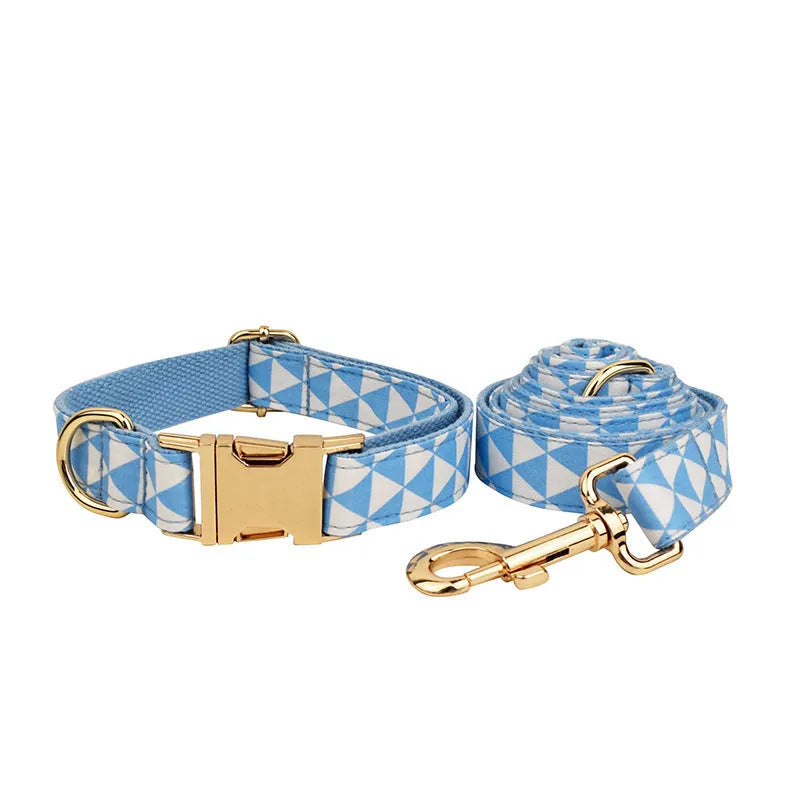 Blue cloth dog vest set with matching collar, lead, and decorative bow on a triangular ring.