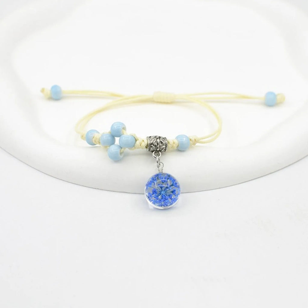 Glass dried flower bracelet with hand-woven beads containing real preserved flowers in various colours