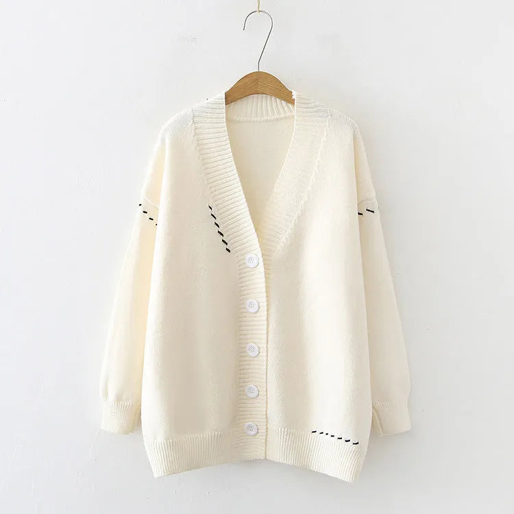 Women's loose fit knitted cardigan coat in black or white polyester with long sleeves