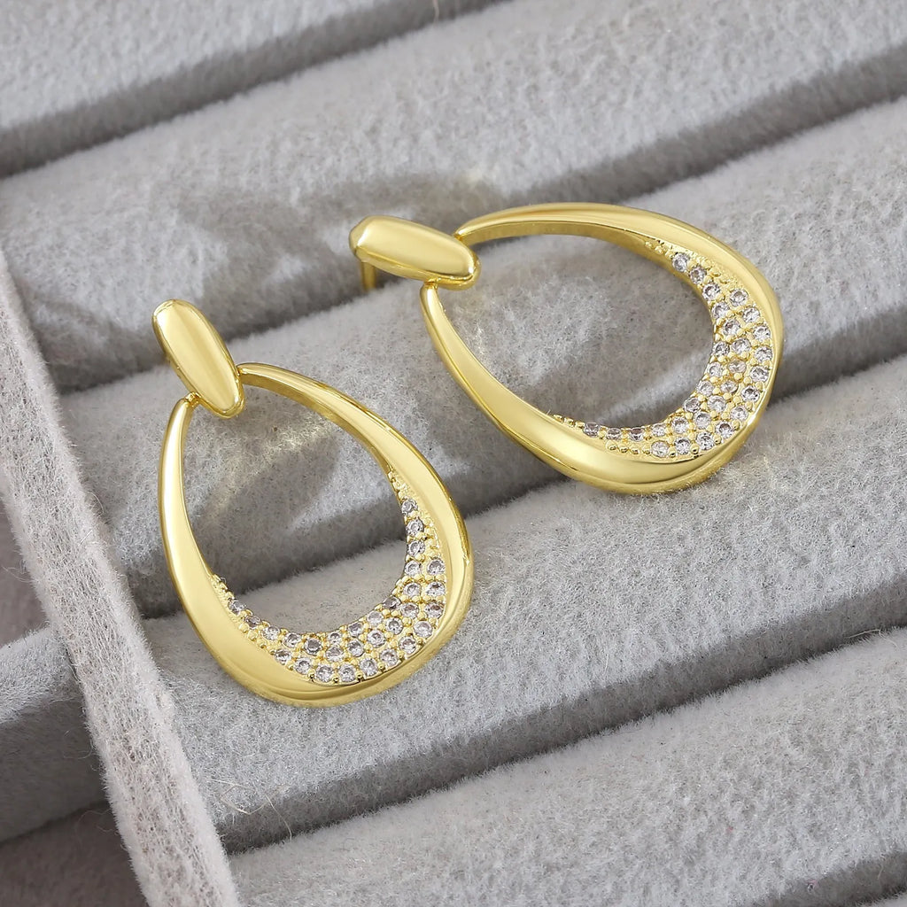 Women's yellow gold geometric drop earrings with ring and oval elements measuring 2.6 by 1.7 cm