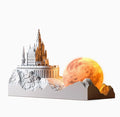 Small mountain-shaped LED night light with touch control, shown as part of a gift box set with essential oil and card for bedroom or desktop decoration.