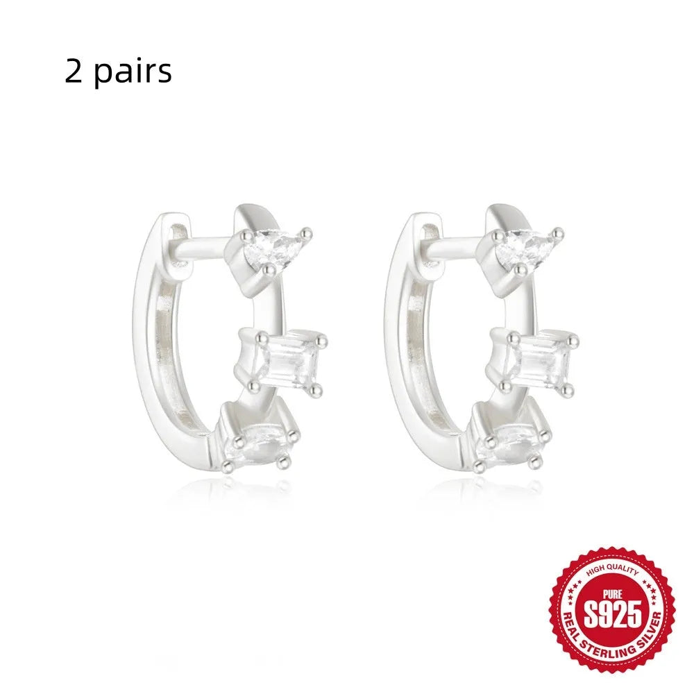 Small round geometric sterling silver stud earrings in gold and silver electroplated finishes.