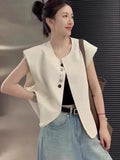 Women's loose fit polyester vest in milky white, showing front view with pockets.
