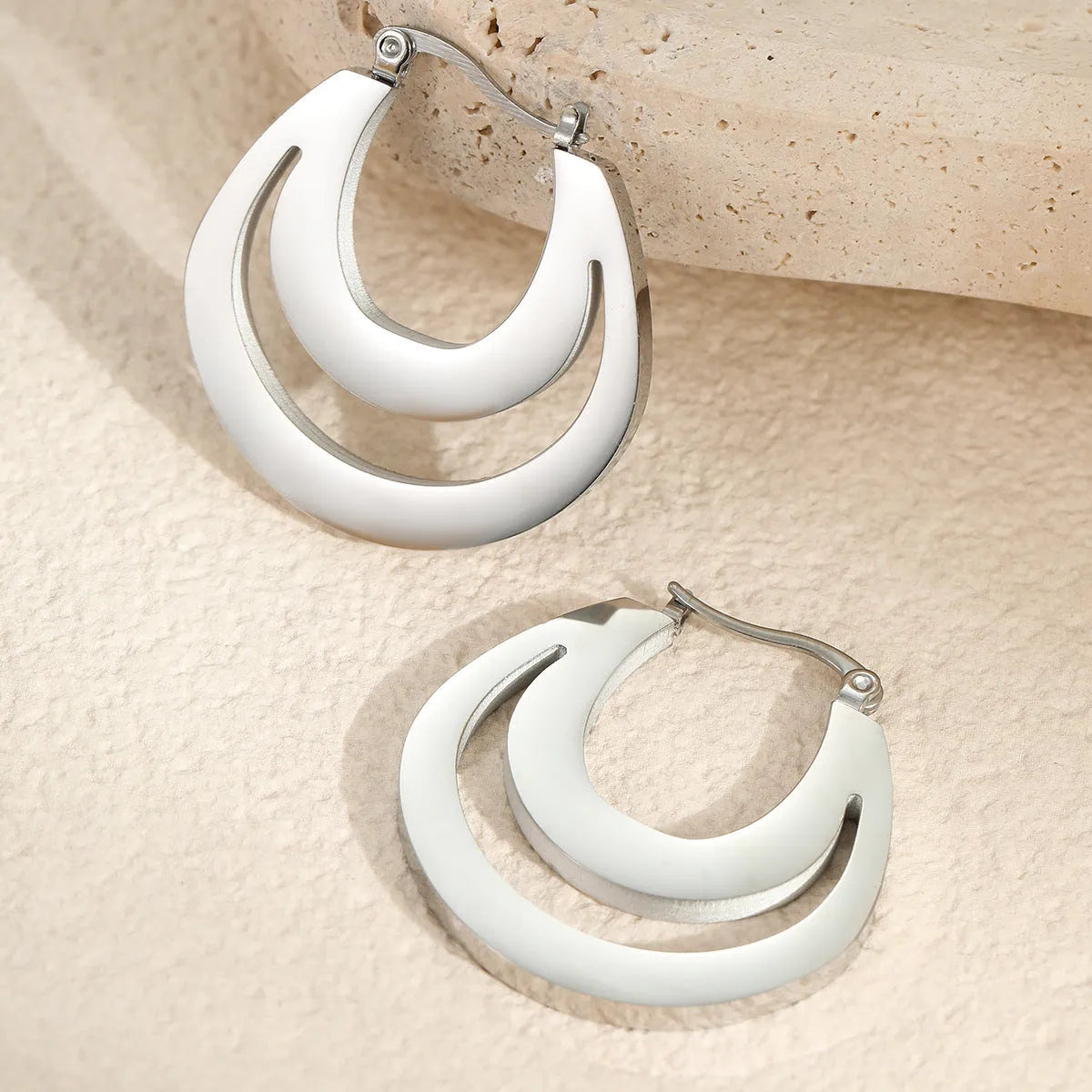 Metallic French geometric earrings with gold plating on stainless steel, featuring round ring elements