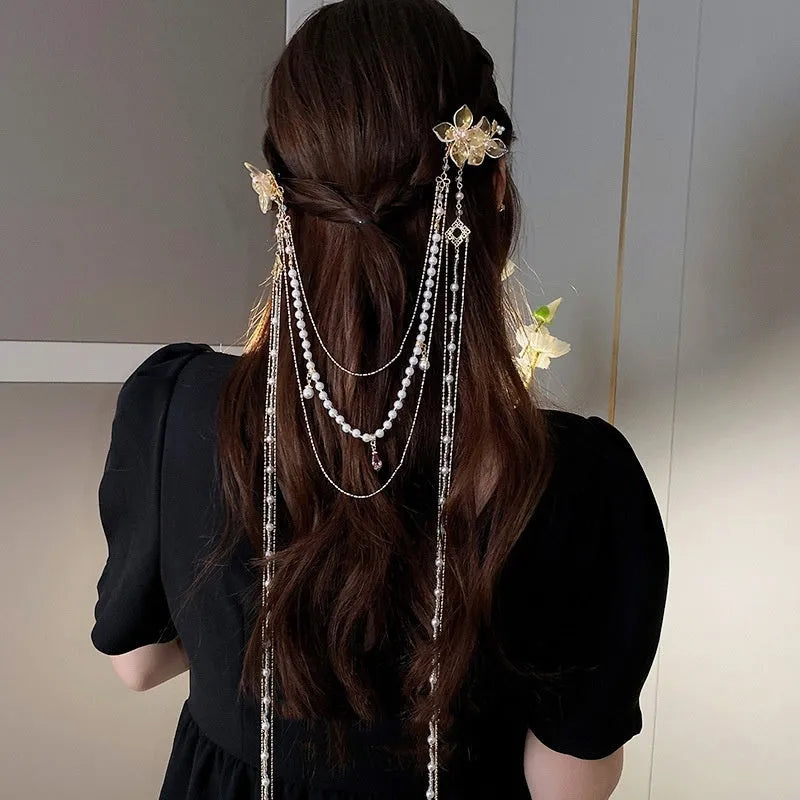 Gold acrylic women's hairpin with flower shape, pearl diamond details, and long tassel design