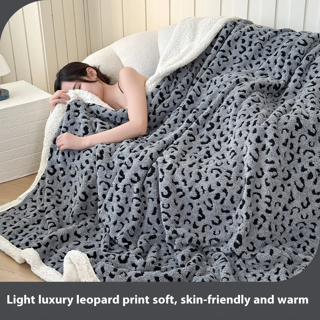 Double-layer jacquard taffeta blanket with leopard print pattern in a camel colour, laid flat on a bed.