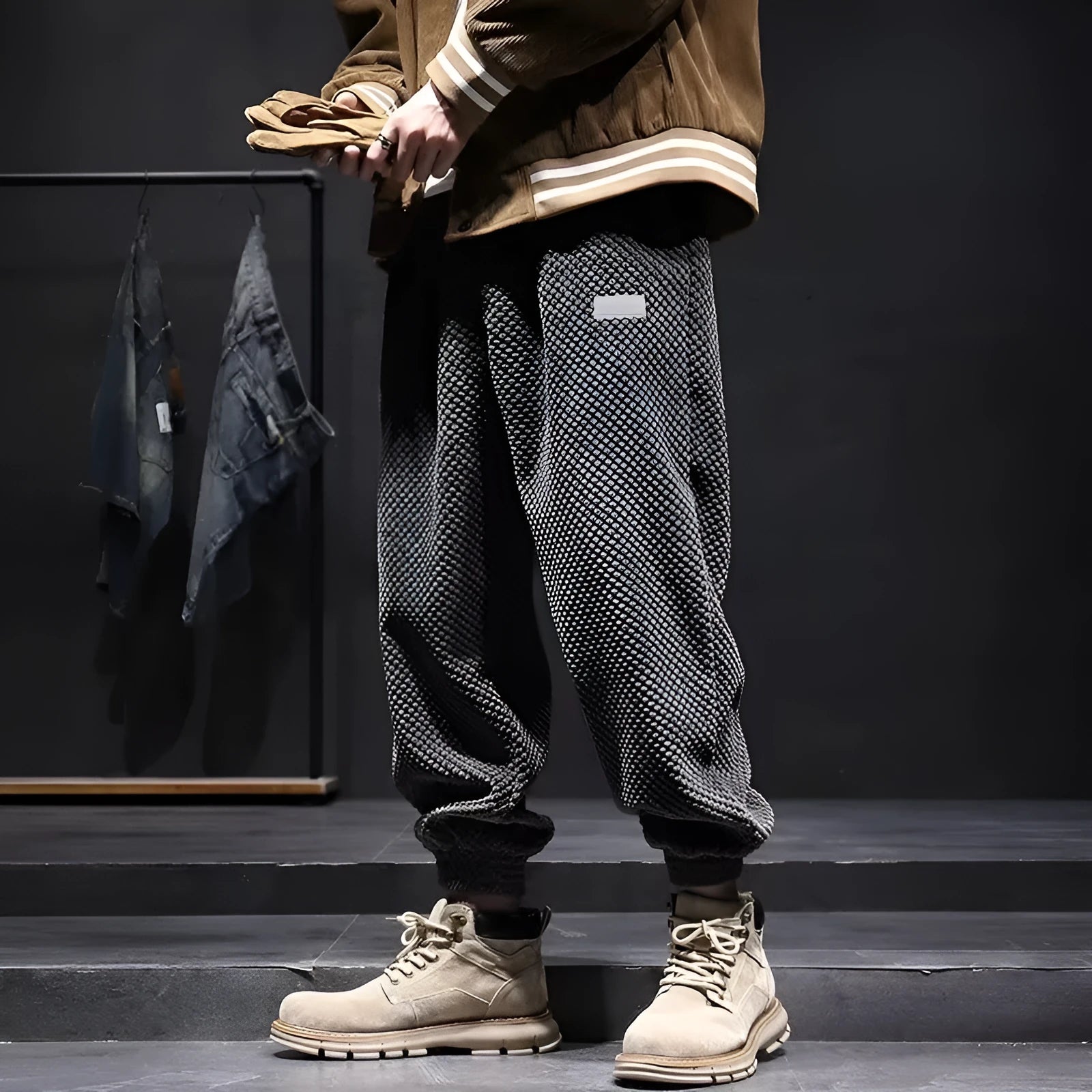 Men's grey ankle-tie sweatpants with a straight leg on a plain background