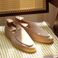 Men's handmade brown leather loafers with a TPR beef tendon sole on a white background.