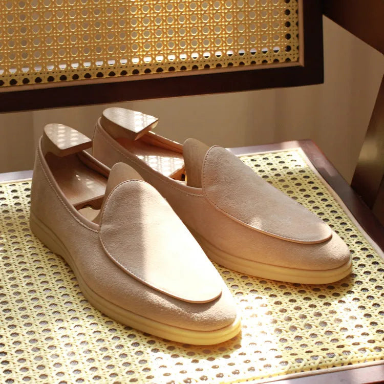 Men's handmade brown leather loafers with a TPR beef tendon sole on a white background.