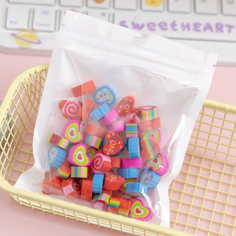 Assortment of 50 small colourful cartoon erasers showing fruit, animal, and aerospace designs.