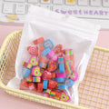 Assortment of 50 small colourful cartoon erasers showing fruit, animal, and aerospace designs.