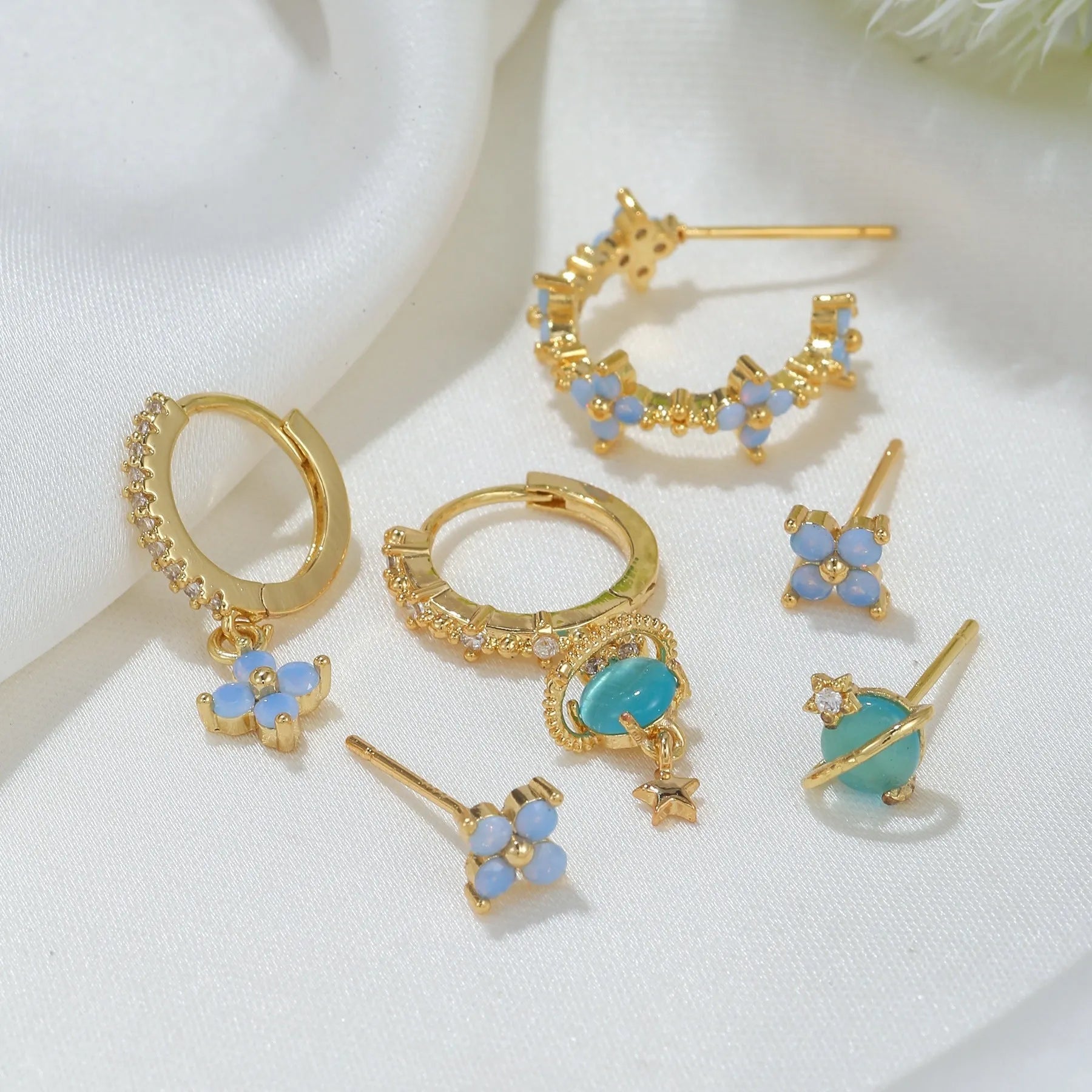 Gold and silver flower-shaped ear studs with zircon mosaic accents in Japanese Korean style