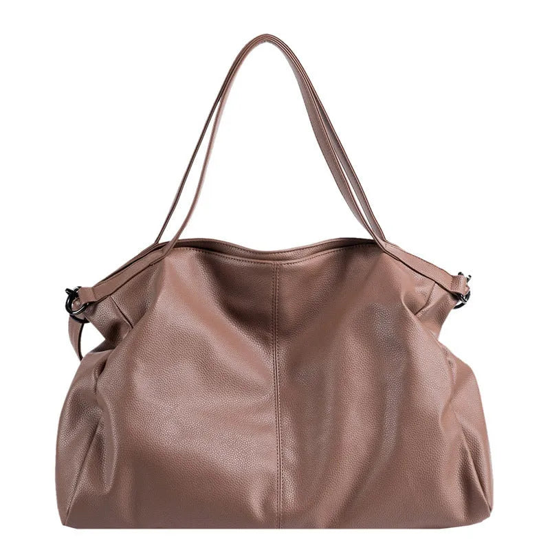 Soft black casual messenger tote bag with zip, showing internal phone pocket and adjustable long shoulder strap.
