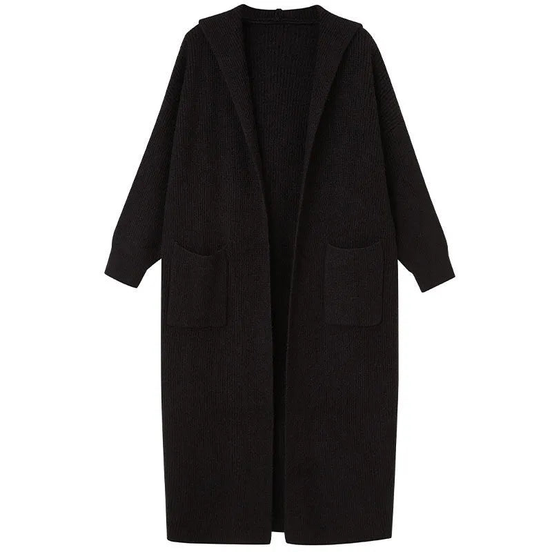 Long grey knitted women's cardigan with a hood, styled like a trench coat, on a hanger.