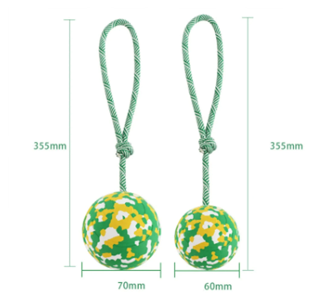 Natural rubber dog ball attached to a blue nylon rope for fetch and tug of war games.