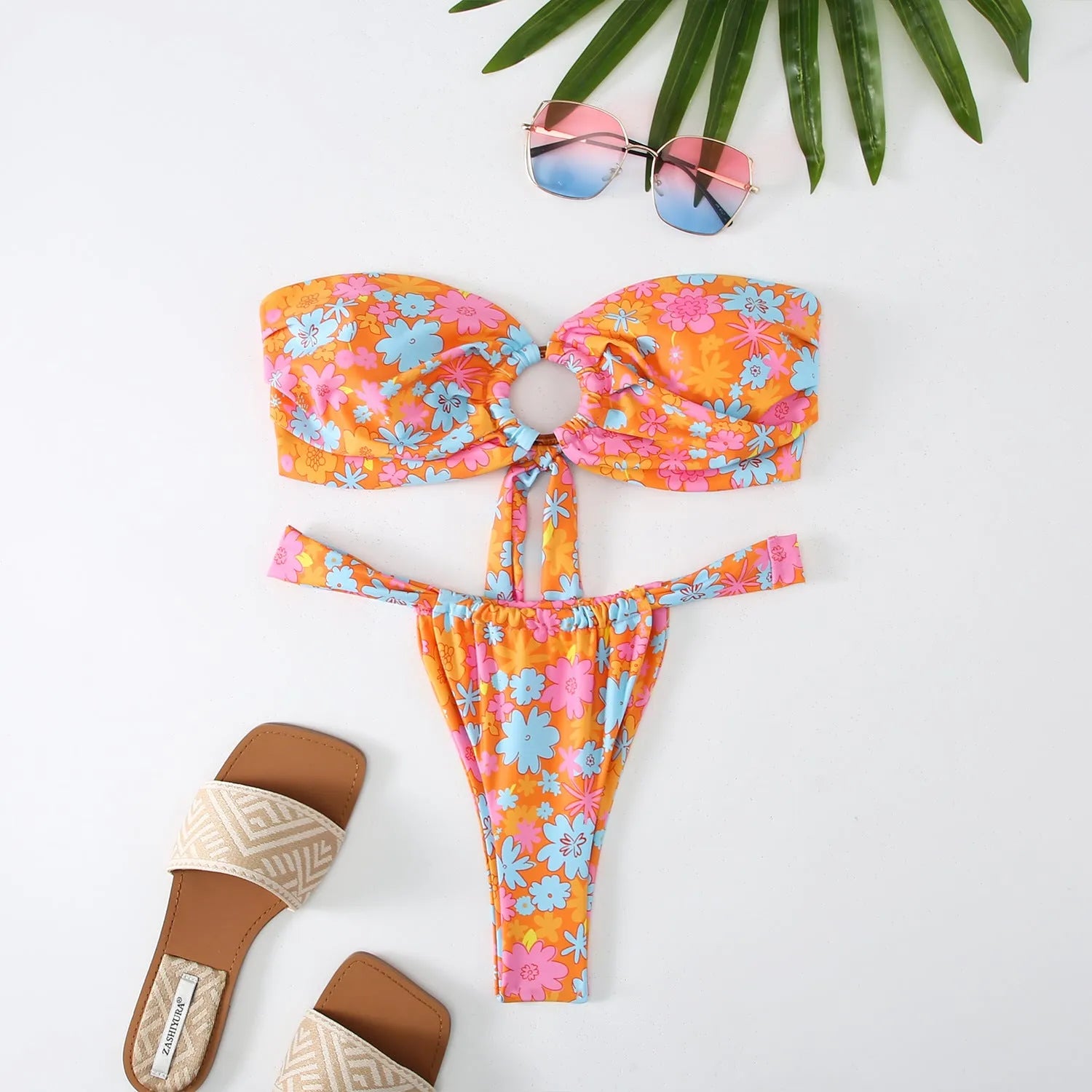 Women's floral print tube top bikini swimsuit on a white background.