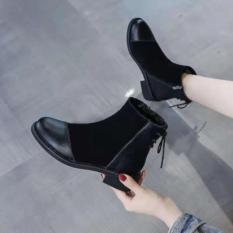 Black women's knee-high Martin boots with side zip, round toe, decorative bow, and rubber sole.