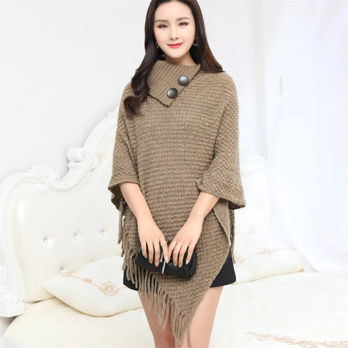 Women's sleeveless knitted cloak shawl with dot pattern in apricot colour