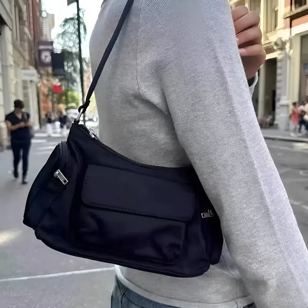 Black lightweight women's shoulder bag with double pockets showing side line detailing