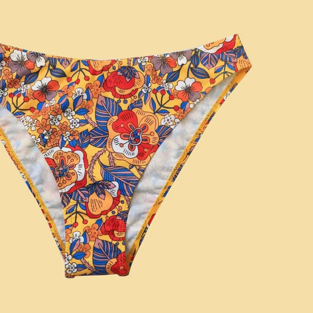 Plus size women's floral print strap bikini swimsuit two-piece set on a mannequin