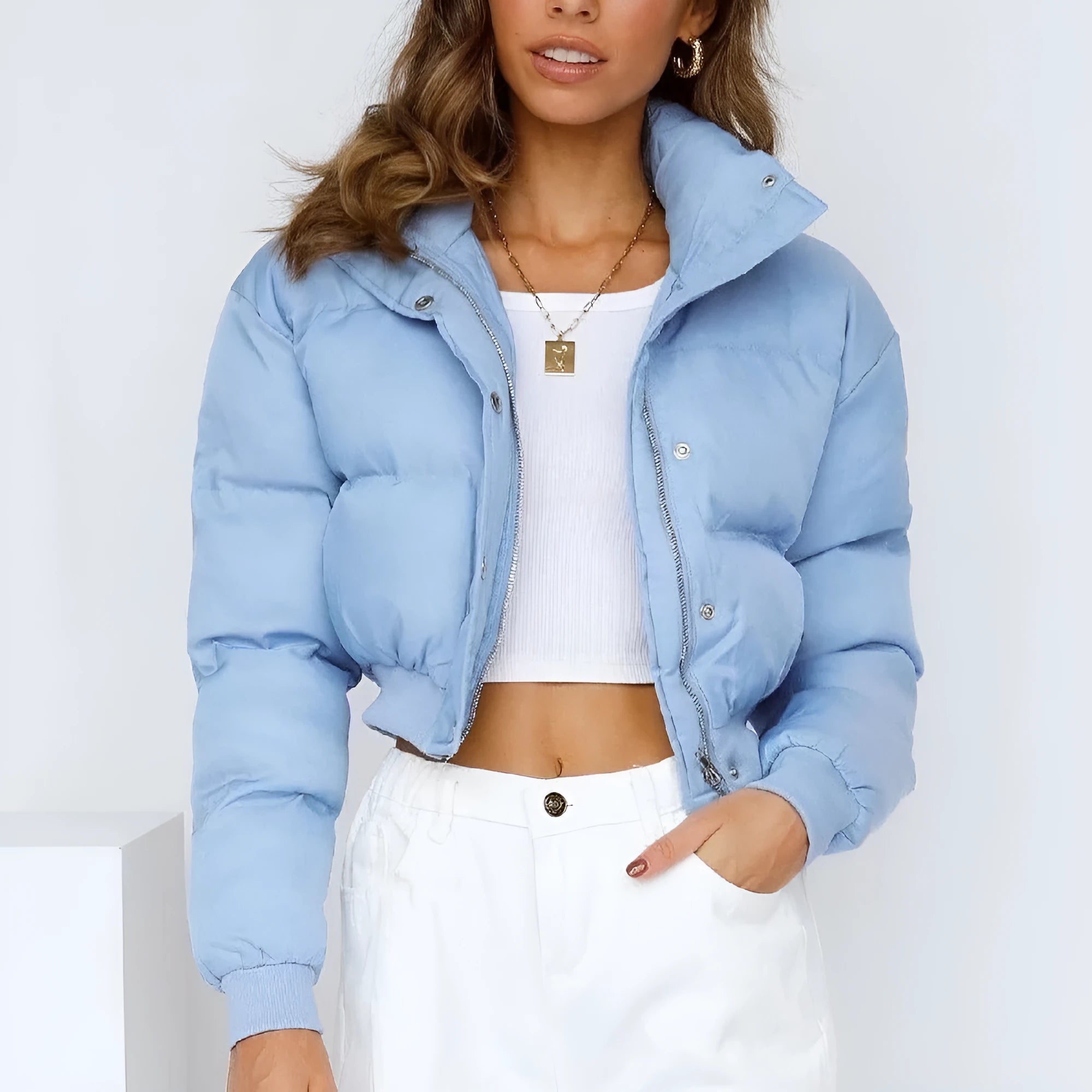 A woman's loose-fitting long-sleeve polyester jacket in blue, shown on a hanger.