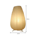 White rice paper plug-in table lamp in circular shape on a wooden bedside table.
