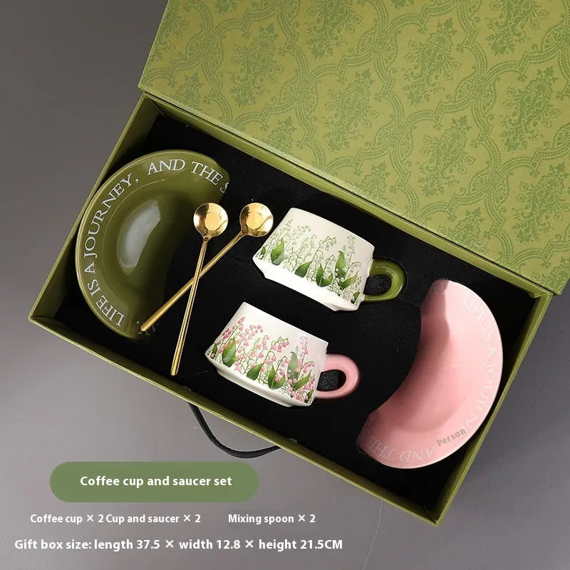 Ceramic coffee cup and saucer set for two in campanula floral design with stirring spoons