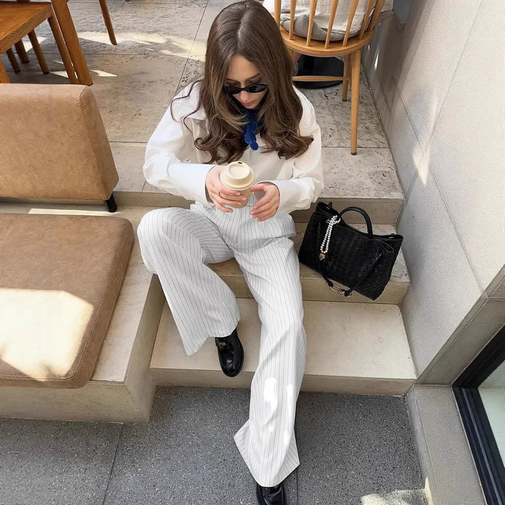 White striped wide-leg casual trousers with zipper detailing on a mannequin.