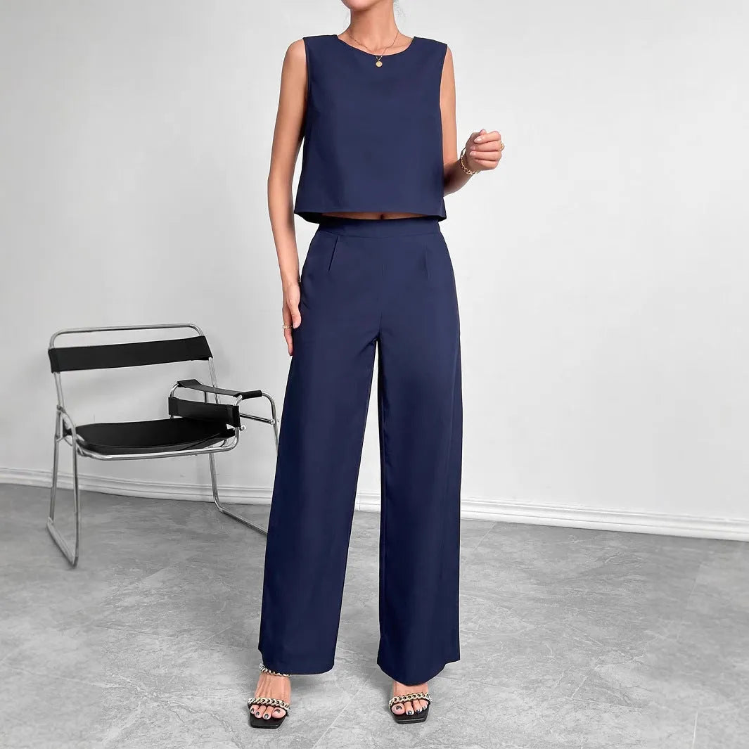 Red polyester women's two-piece set with sleeveless top and wide-leg trousers laid flat.
