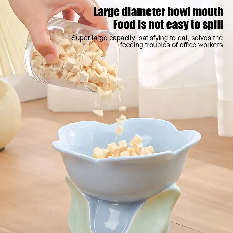 Blue ceramic elevated pet bowl with floral pattern and non-slip base for cat or small dog
