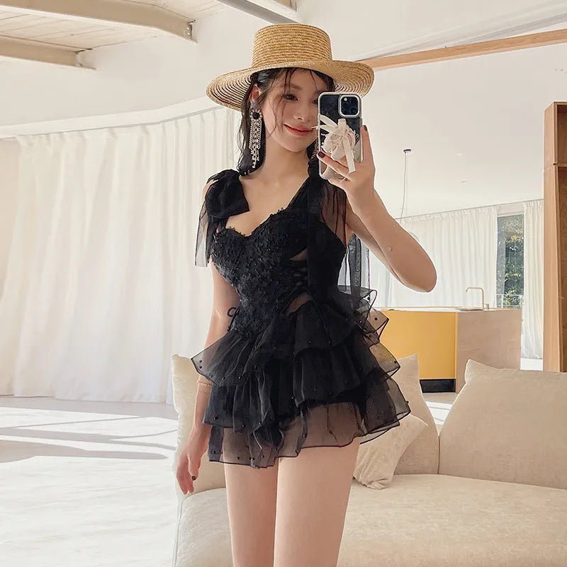 Black conservative one-piece swimsuit with chest gathering detail