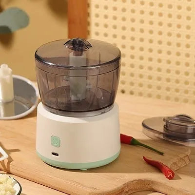 Mini electric meat grinder with transparent cup and stainless steel blades in white or light green