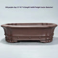 Handmade antique purple sand rectangular begonia flower pot on a desktop.
