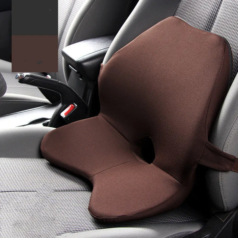 Black memory foam car lumbar support cushion with elastic straps, shown on a grey car seat.