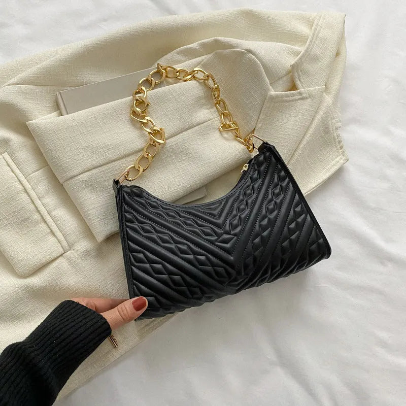 Brown pleated chain shoulder bag with soft handle and adjustable strap showing sewing line detailing