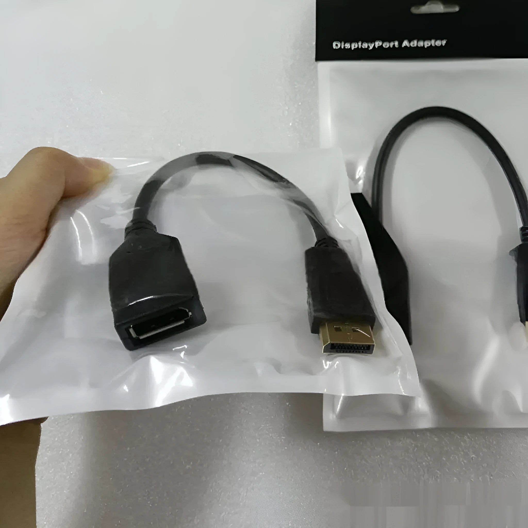 Black Display Port DP male to female extension cable approximately 10cm long with rotating adapter