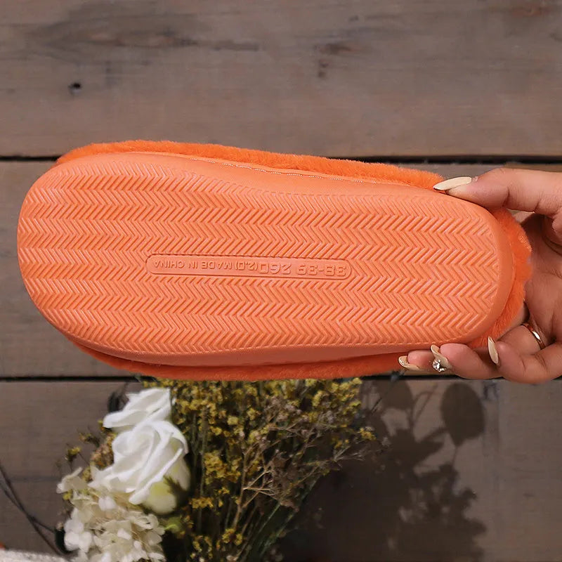 Orange plush Halloween pumpkin slippers with coral velvet upper and flat PVC sole.