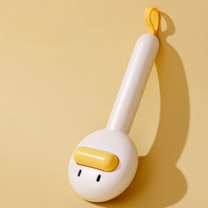 Small yellow duck-shaped pet grooming comb with open needle brush for cats and dogs