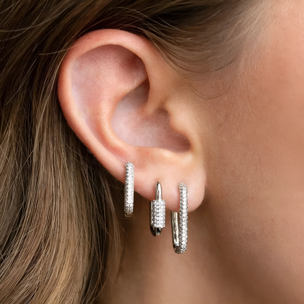 Three geometric copper ear clips with micro inlaid zircon stones in gold and white gold finishes