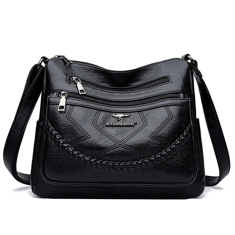 Soft PU leather women's shoulder bag in black colour showing crossbody strap and exterior pockets