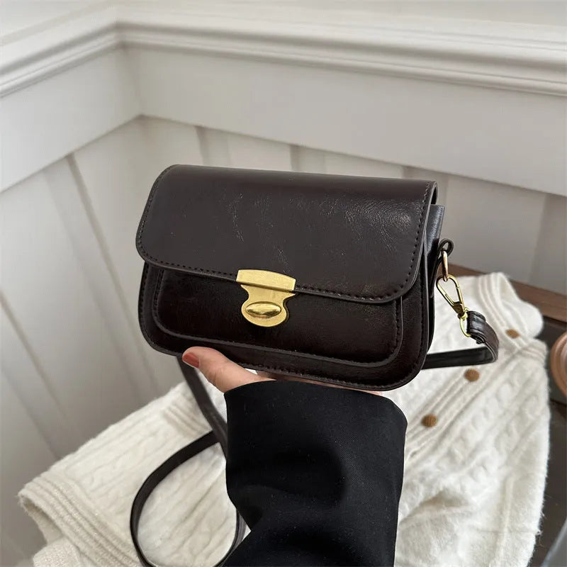 Retro-style square handbag in soft PU leather showing horizontal structure and shoulder strap