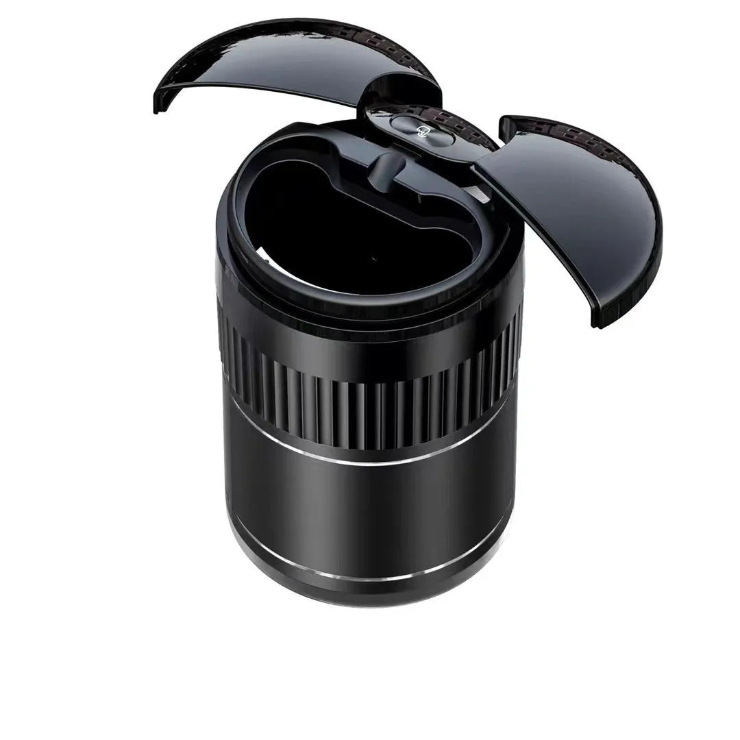 Smart black metal car ashtray with lid, showing compact size next to a charging cable.