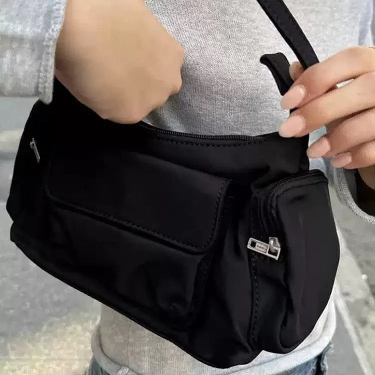 Black lightweight women's shoulder bag with double pockets showing side line detailing