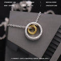 Geometric copper nested necklace with gold and silver electroplated finish, round and ring elements, on display